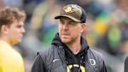 Oregon offensive coordinator Will Stein, left, former Oregon defensive coordinator Nick Aliotti and former Oregon coach Rich Brooks talk before the game as the Fighting Ducks face off against Mighty Oregon in the Oregon Ducks spring game on April 26, 2025, at Autzen Stadium in Eugene.