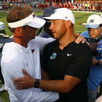 Oxford, Mississippi, USA; Mississippi Rebels head coach Lane Kiffin (left) and Tulane Green Wave head coach Jon Sumrall (right) embrace after the game at Vaught-Hemingway Stadium.