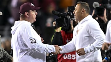 Nov 30, 2024; College Station, Texas, USA; Texas A&M Aggies head coach Mike Elko, left, shakes hands with Texas Longhorns head coach Steve Sarkisian after the game.