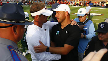 Sep 20, 2025; Oxford, Mississippi, USA; Mississippi Rebels head coach Lane Kiffin (left) and Tulane Green Wave head coach Jon Sumrall (right) embrace after the game at Vaught-Hemingway Stadium. Mandatory Credit: Petre Thomas-Imagn Images