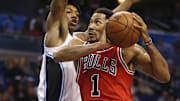 Mar 2, 2016; Orlando, FL, USA; Chicago Bulls guard Derrick Rose (1) drives past Orlando Magic guard Elfrid Payton (4) during the first quarter of a basketball game at Amway Center. Mandatory Credit: Reinhold Matay-Imagn Images