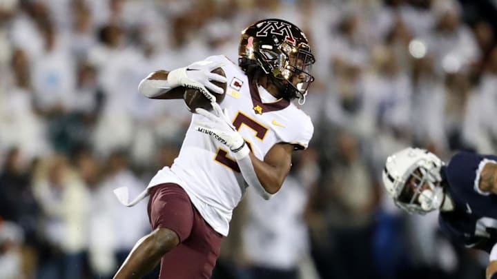 Oct 22, 2022; University Park, Pennsylvania, USA; Minnesota Golden Gophers defensive back Justin Walley (5) runs with the ball following an interception during the first quarter against the Penn State Nittany Lions at Beaver Stadium. Oct 22, 2022; University Park, Pennsylvania, USA; Minnesota Golden Gophers defensive back Justin Walley (5) runs with the ball following an interception during the first quarter against the Penn State Nittany Lions at Beaver Stadium.