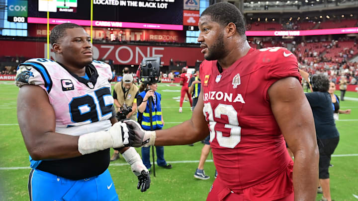 Sep 14, 2025; Glendale, Arizona, USA; Arizona Cardinals defensive tackle Calais Campbell (93) shakes hands with Carolina Panthers defensive end Derrick Brown (95) after the win against the Carolina Panthers at State Farm Stadium. 