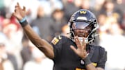 Dec 1, 2024; Landover, Maryland, USA; Washington Commanders quarterback Jayden Daniels (5) throws a pass during the first half against the Tennessee Titans at Northwest Stadium. Mandatory Credit: Amber Searls-Imagn Images