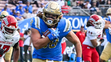 Nov 30, 2024; Pasadena, California, USA; UCLA Bruins tight end Moliki Matavao (88) Fresno State Bulldogs defensive back Jakari Embry (17) during the first quarter at Rose Bowl. Mandatory Credit: Robert Hanashiro-Imagn Images