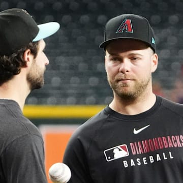 Arizona Diamondbacks pitchers Zac Gallen and Corbin Burnes talk before playing the San Francisco Giants at Chase Field on Sept. 17, 2025.