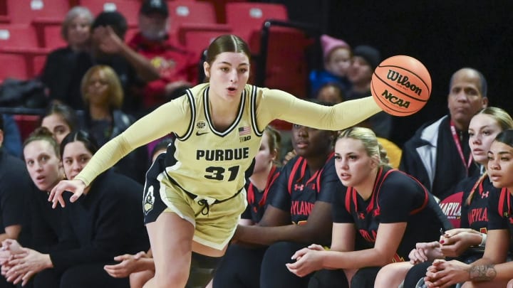 Jan 14, 2024; College Park, Maryland, USA;  Purdue Boilermakers guard Sophie Swanson (31) reaches for a loose ball along the sidelines during the first half against the Maryland Terrapins at Xfinity Center. Mandatory Credit: Tommy Gilligan-USA TODAY Sports