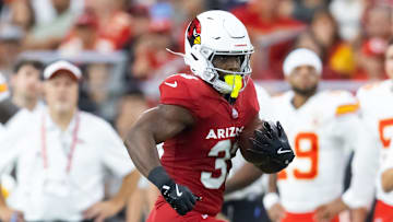 Aug 9, 2025; Glendale, Arizona, USA; Arizona Cardinals running back Trey Benson (33) against the Kansas City Chiefs during a preseason NFL game at State Farm Stadium. Mandatory Credit: Mark J. Rebilas-Imagn Images