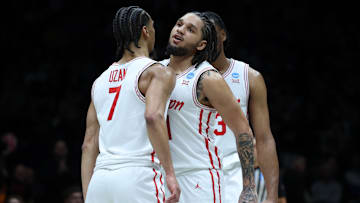 Houston's Milos Uzan (7) and Emanuel Sharp celebrate after the Cougars' Sweet 16 win against Purdue on March 28, 2025.