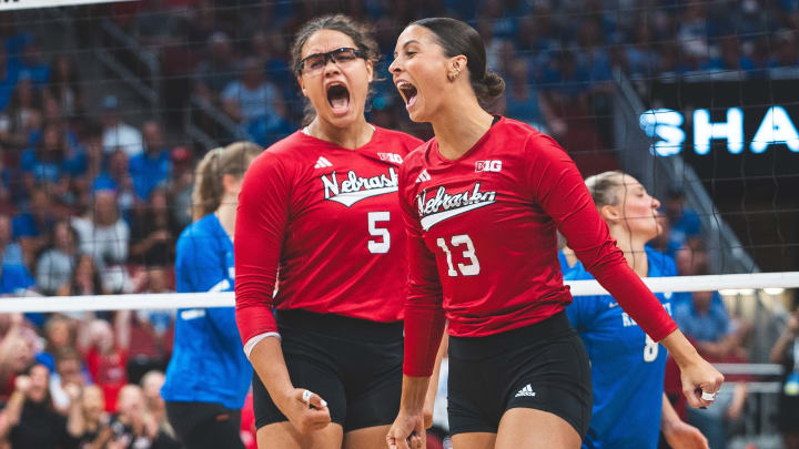 Nebraska volleyball middle blocker Rebekah Allick (left) and right side Merritt Beason celebrate a point against Kentucky during the AVCA First Serve Showcase.