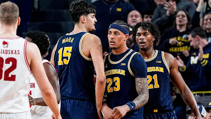 From left, Michigan center Aday Mara (15) and forwards Yaxel Lendeborg (23) and Morez Johnson Jr. (21), celebrate a play against Wisconsin during the second half at Crisler Center in Ann Arbor on Saturday, Jan. 10, 2026.