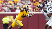 Sep 14, 2024; Minneapolis, Minnesota, USA; Nevada Wolf Pack wide receiver Cortez Braham Jr. (8) catches a pass as Minnesota Golden Gophers defensive back Darius Green (12) defends during the first half at Huntington Bank Stadium. Mandatory Credit: Matt Krohn-Imagn Images