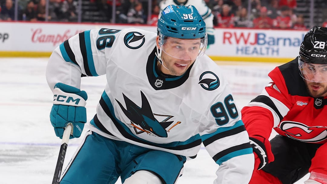 Oct 24, 2025; Newark, New Jersey, USA; San Jose Sharks center Philipp Kurashev (96) skates with the puck as New Jersey Devils right wing Timo Meier (28) defends during the third period at Prudential Center. Mandatory Credit: Ed Mulholland-Imagn Images