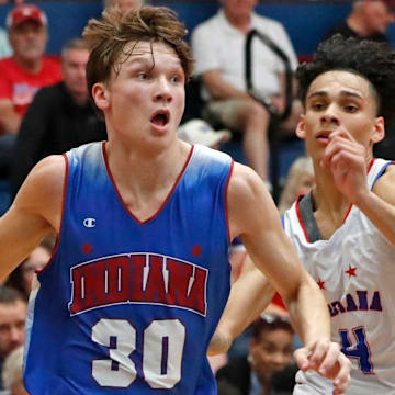 Indiana Junior All-Star Braylon Mullins (30) drives past Indiana Senior All-Star Micah Davis (4) during the Indiana Boys Junior-Senior All-Star Game on June 5, 2024 at Kokomo Memorial Gym.