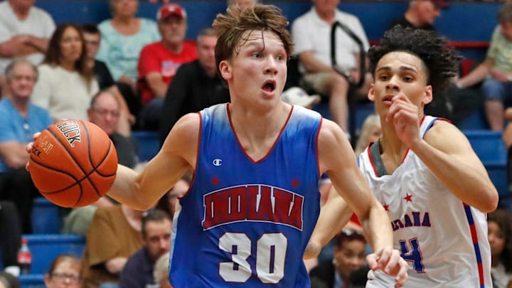 Indiana Junior All-Star Braylon Mullins (30) drives past Indiana Senior All-Star Micah Davis (4) during the Indiana Boys Junior-Senior All-Star Game on June 5, 2024 at Kokomo Memorial Gym.