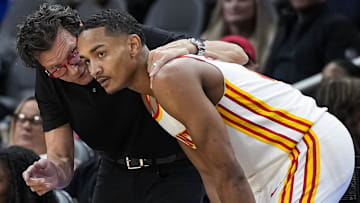 Atlanta Hawks head coach Quin Snyder talks to guard Kobe Bufkin (4) during the game against the Cleveland Cavaliers during the second half at State Farm Arena.