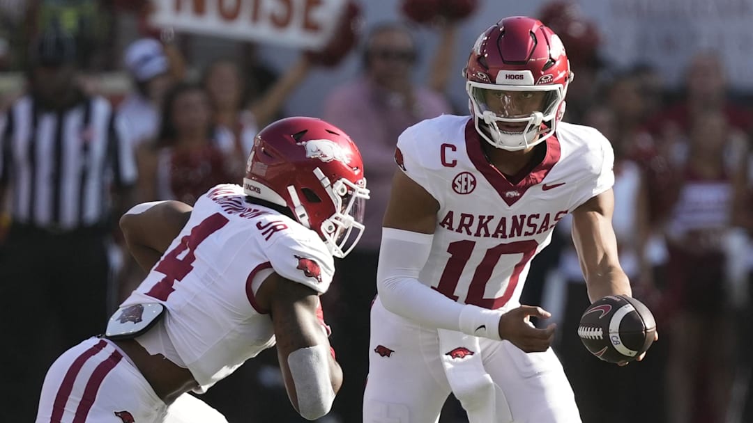 Arkansas Razorbacks quarterback Taylen Green (10) hands the ball off to running back Mike Washington Jr. (4) during the first half against the Texas Longhorns at Darrell K Royal-Texas Memorial Stadium.