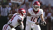 Arkansas Razorbacks quarterback Taylen Green (10) hands the ball off to running back Mike Washington Jr. (4) during the first half against the Texas Longhorns at Darrell K Royal-Texas Memorial Stadium.