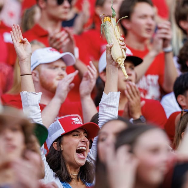 Nebraska football fan in Memorial Stadium with ear of corn