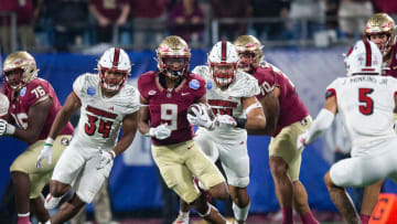 Florida State running back Lawrance Toafili (9) dodges Louisville defenders during the ACC championship title in Charlotte, North Carolina on Saturday, Dec. 2, 2023.