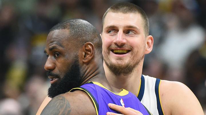Feb 22, 2025; Denver, Colorado, USA; Denver Nuggets center Nikola Jokic (15) and Los Angeles Lakers forward LeBron James (23) hug before the game at Ball Arena. Mandatory Credit: Christopher Hanewinckel-Imagn Images