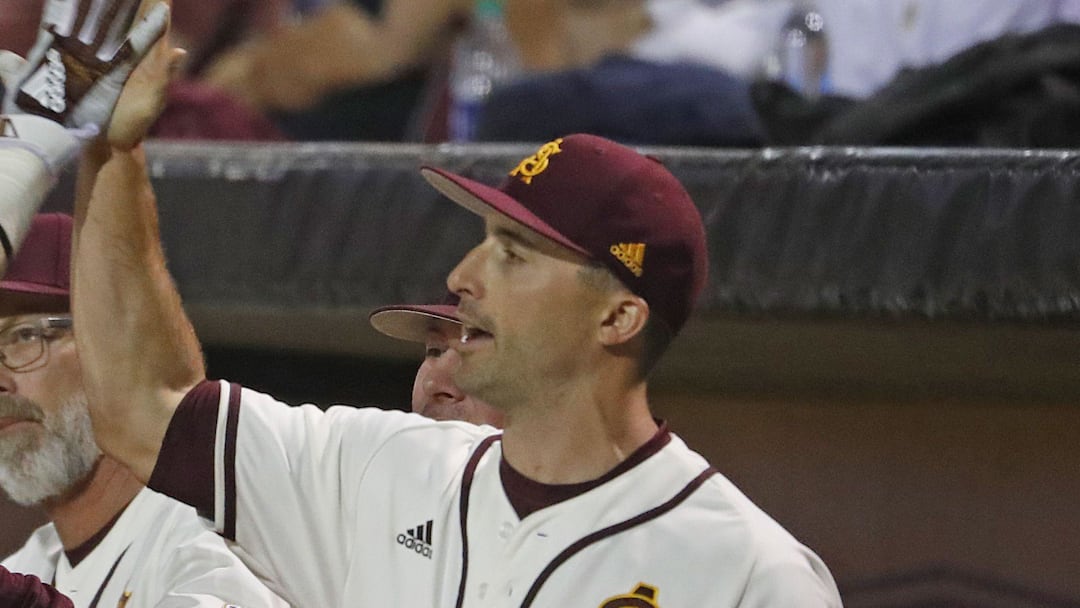 ASU's Gage Workman (14) high fives with head coach Tracy Smith (center) and hitting coach Michael Earley (R) after scoring during the first inning against Arizona at Phoenix Municipal Stadium in Phoenix, Ariz. on March 30, 2019 ASU's Gage Workman (14) high fives with head coach Tracy Smith (center) and hitting coach Michael Earley (R) after scoring during the first inning against Arizona at Phoenix Municipal Stadium in Phoenix, Ariz. on March 30, 2019