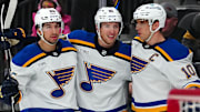 Jan 20, 2025; Las Vegas, Nevada, USA; St. Louis Blues center Brayden Schenn (10) celebrates with center Dylan Holloway (81) and center Jordan Kyrou (25) after scoring a goal against the Vegas Golden Knights during the first period at T-Mobile Arena. Mandatory Credit: Stephen R. Sylvanie-Imagn Images