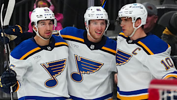 Jan 20, 2025; Las Vegas, Nevada, USA; St. Louis Blues center Brayden Schenn (10) celebrates with center Dylan Holloway (81) and center Jordan Kyrou (25) after scoring a goal against the Vegas Golden Knights during the first period at T-Mobile Arena. Mandatory Credit: Stephen R. Sylvanie-Imagn Images