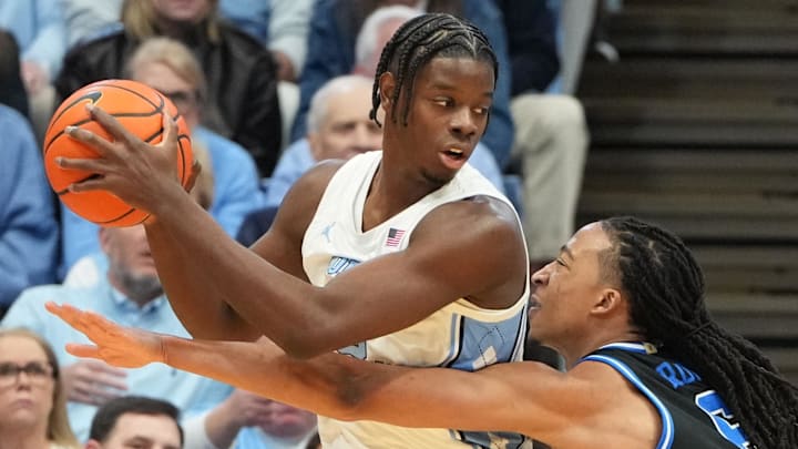 Feb 7, 2026; Chapel Hill, North Carolina, USA;  North Carolina Tar Heels forward Caleb Wilson (8) with the ball as Duke Blue Devils forward Maliq Brown (6) defends in the first half at Dean E. Smith Center. Mandatory Credit: Bob Donnan-Imagn Images