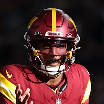 Washington Commanders quarterback Jayden Daniels calls a play at the line of scrimmage against the Dallas Cowboys.