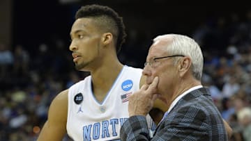 Mar 21, 2015; Jacksonville, FL, USA; North Carolina Tar Heels head coach Roy Williams watches the action fron the bench against the Arkansas Razorbacks with Tar Heels forward J.P. Tokoto (13) in the first half of a game in the third round of the 2015 NCAA Tournament at Jacksonville Veterans Memorial Arena. Mandatory Credit: Tommy Gilligan-Imagn Images