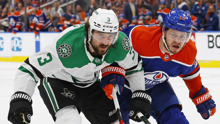 May 27, 2024; Edmonton, Alberta, CAN; Dallas Stars defensemen Chris Tanev (3) and Edmonton Oilers forward Mattias Janmark (13) battle for a loose puck during the first period in game three of the Western Conference Final of the 2024 Stanley Cup Playoffs at Rogers Place. Mandatory Credit: Perry Nelson-USA TODAY Sports