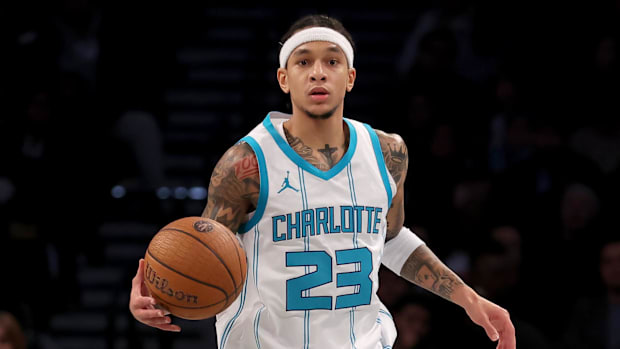 Charlotte Hornets guard Tre Mann (23) brings the ball up court against the Brooklyn Nets