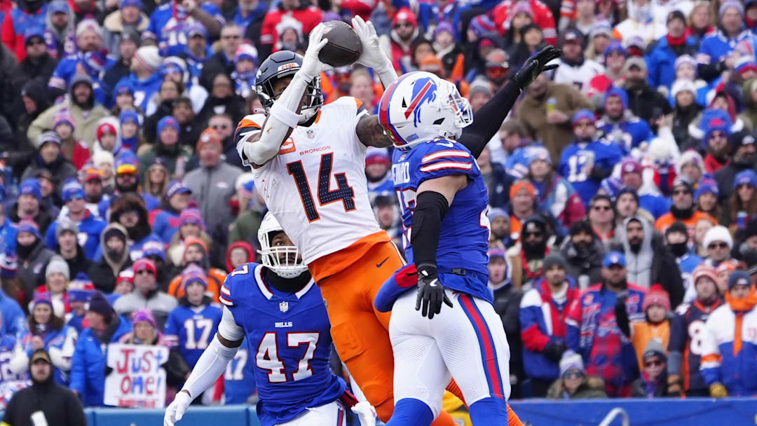 Jan 12, 2025; Orchard Park, New York, USA; Denver Broncos wide receiver Courtland Sutton (14) catches a pass as Buffalo Bills linebacker Terrel Bernard (43) defends during the second quarter in an AFC wild card game at Highmark Stadium. 
