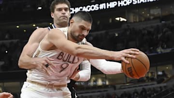 Dec 28, 2024; Chicago, Illinois, USA;  Milwaukee Bucks center Brook Lopez (11) fouls Chicago Bulls center Nikola Vucevic (9) during the second half at the United Center. Mandatory Credit: Matt Marton-Imagn Images