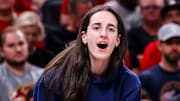 Indiana Fever guard Caitlin Clark cheers on her team from the sidelines.