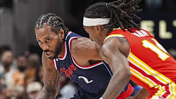 Mar 14, 2025; Atlanta, Georgia, USA; LA Clippers forward Kawhi Leonard (2) dribbles against Atlanta Hawks guard Terance Mann (14) during the second half at State Farm Arena. Mandatory Credit: Dale Zanine-Imagn Images