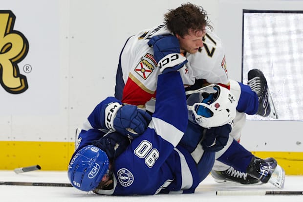 Hockey players battle on the ic