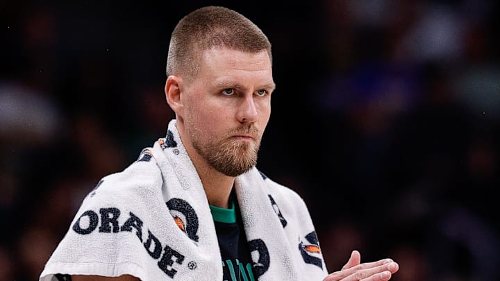 Jan 7, 2025; Denver, Colorado, USA; Boston Celtics center Kristaps Porzingis (8) reacts from the sideline in the second quarter against the Denver Nuggets at Ball Arena. Mandatory Credit: Isaiah J. Downing-Imagn Images