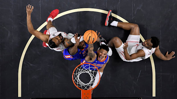 Florida's Will Richard holds the ball above the rim.