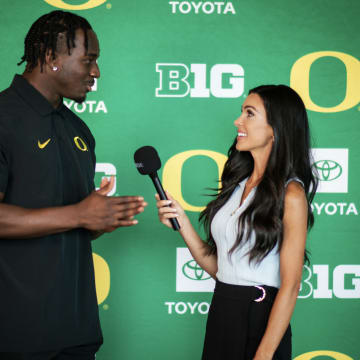 Oregon Ducks linebacker Jeffrey Bassa with reporter Bri Amaranthus