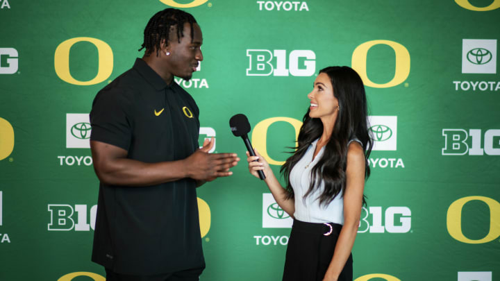 Oregon Ducks linebacker Jeffrey Bassa with reporter Bri Amaranthus