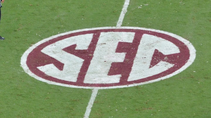 A view of the SEC logo on the field during a college football game.