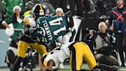 Dec 15, 2024; Philadelphia, Pennsylvania, USA; Philadelphia Eagles running back Kenneth Gainwell (14) is upended by Pittsburgh Steelers safety Damontae Kazee (23) and cornerback Donte Jackson (26) during the second quarter at Lincoln Financial Field. Mandatory Credit: Eric Hartline-Imagn Images