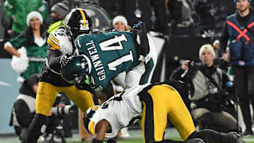 Dec 15, 2024; Philadelphia, Pennsylvania, USA; Philadelphia Eagles running back Kenneth Gainwell (14) is upended by Pittsburgh Steelers safety Damontae Kazee (23) and cornerback Donte Jackson (26) during the second quarter at Lincoln Financial Field. Mandatory Credit: Eric Hartline-Imagn Images