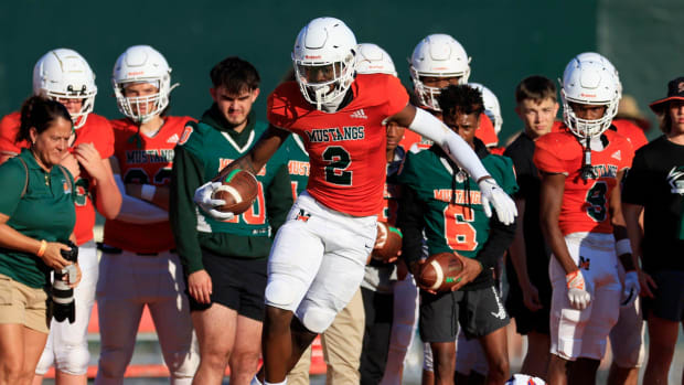 Mandarin's Jaime Ffrench (2) is tripped up during the first quarter of a high school football matchup