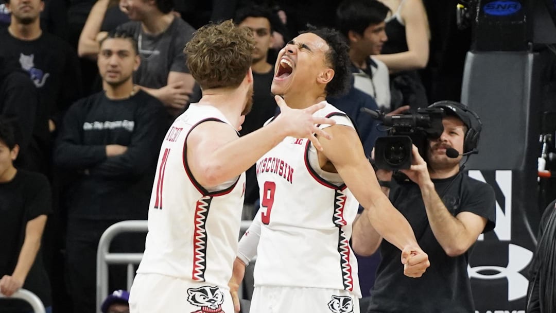 Feb 1, 2025; Evanston, Illinois, USA; Wisconsin Badgers guard John Tonje (9) and guard Max Klesmit (11) celebrate their win against the Northwestern Wildcats during the second half at Welsh-Ryan Arena. Mandatory Credit: David Banks-Imagn Images
