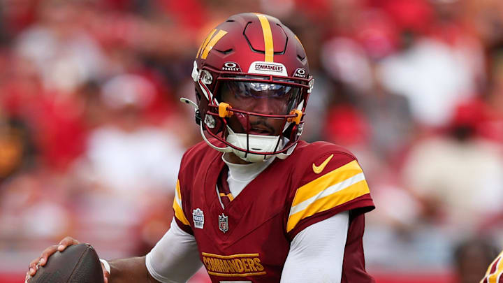 Sep 8, 2024; Tampa, Florida, USA; Washington Commanders quarterback Jayden Daniels (5) drops back to pass against the Tampa Bay Buccaneers in the third quarter at Raymond James Stadium. Mandatory Credit: Nathan Ray Seebeck-Imagn Images