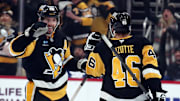 Dec 7, 2024; Pittsburgh, Pennsylvania, USA;  Pittsburgh Penguins defenseman Kris Letang (58) congratulates center Blake Lizotte (46) after Lizotte scored an empty net goal against the Toronto Maple Leafs during the third period at PPG Paints Arena.