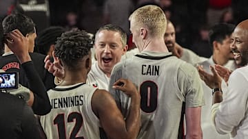 Mar 8, 2025; Athens, Georgia, USA; Georgia Bulldogs head coach Mike White reacts with guard Markel Jennings (12) and guard Blue Cain (0) after Georgia defeated the Vanderbilt Commodores at Stegeman Coliseum. Mandatory Credit: Dale Zanine-Imagn Images